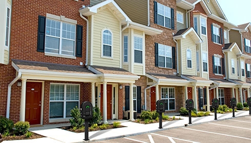 A row of townhouses with parking lot