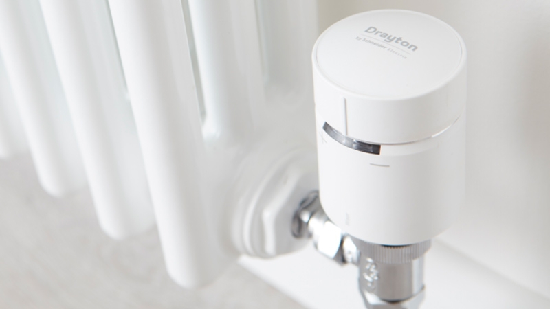 Close-up of a radiator with a white valve