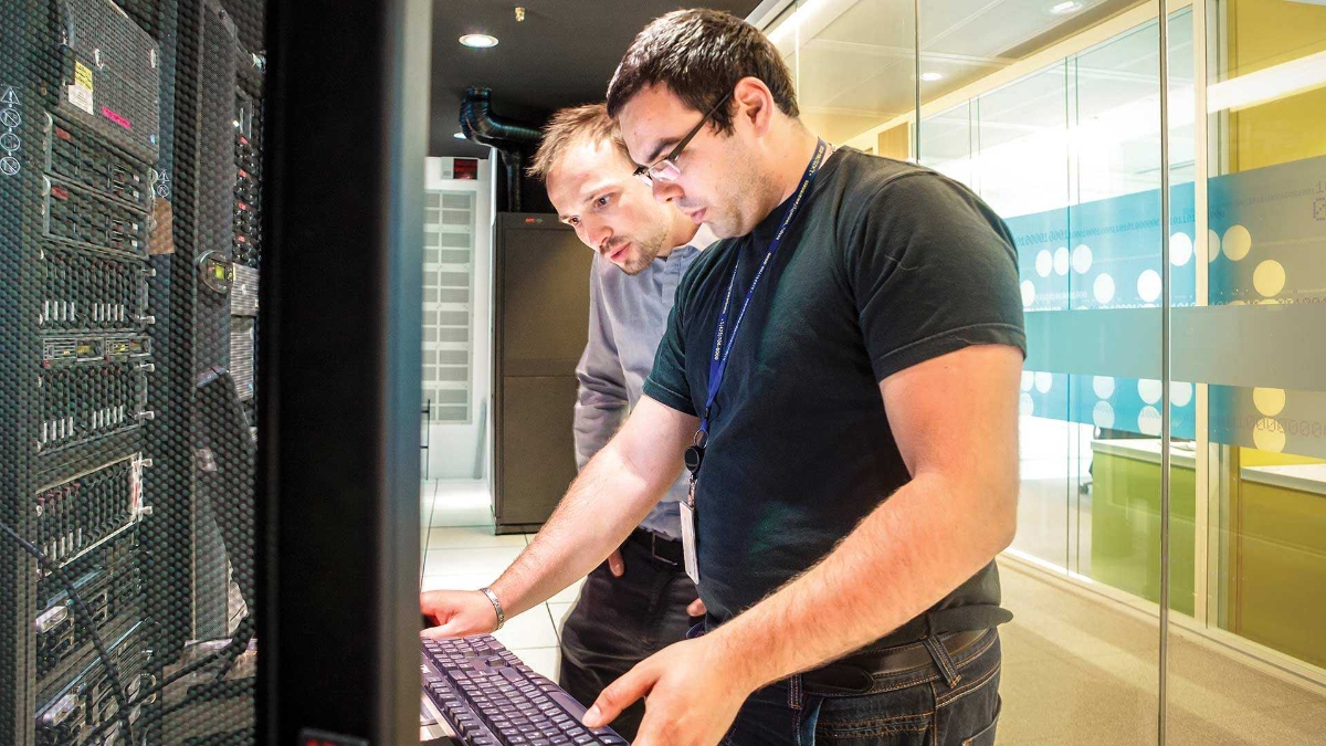 two chinese men working in the data center