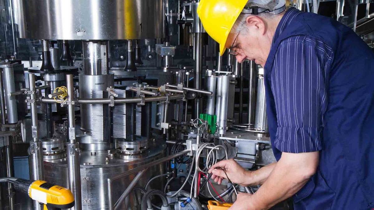 A man working on machine in a factory