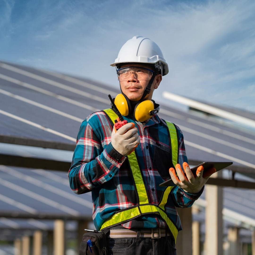 Electrician standing in solar Power plant 