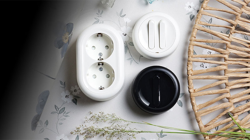 A white outlet and black round object