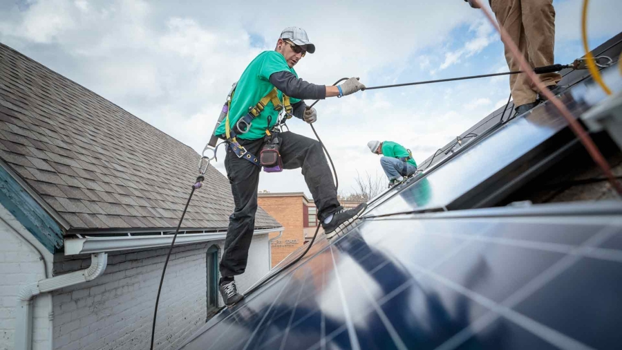 workers installing rooftop solar panels
