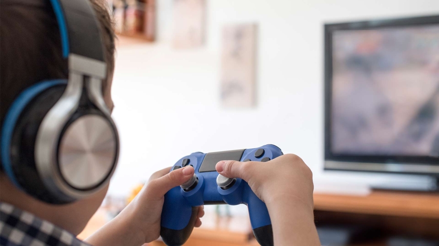 A boy using headset and playing game
