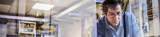 Computer technician in server room, data center operations