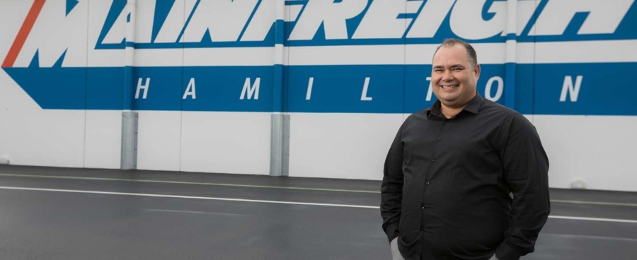 Man in front of logo on racetrack, Mainfreight customer story