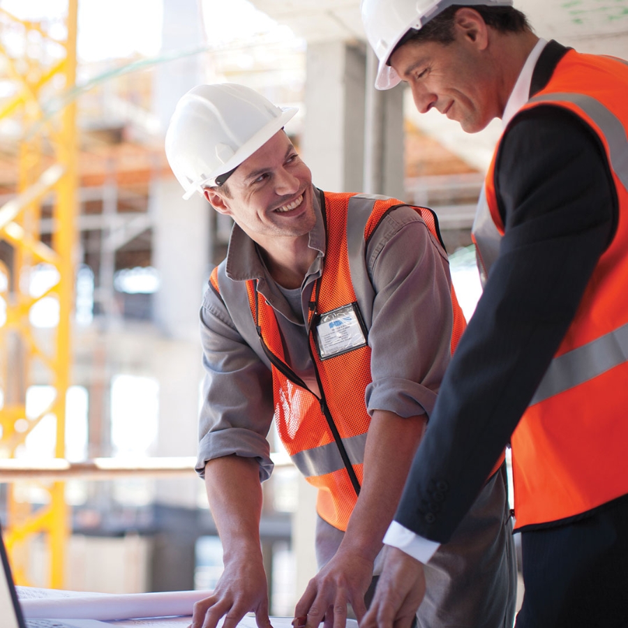 Two construction workers smiling