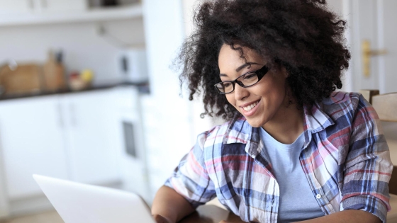 smiling girl working on a laptop