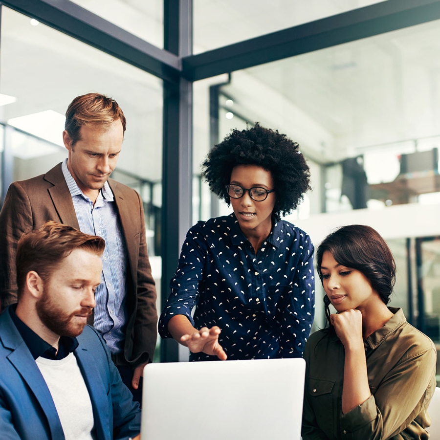 Four team members discussing in office