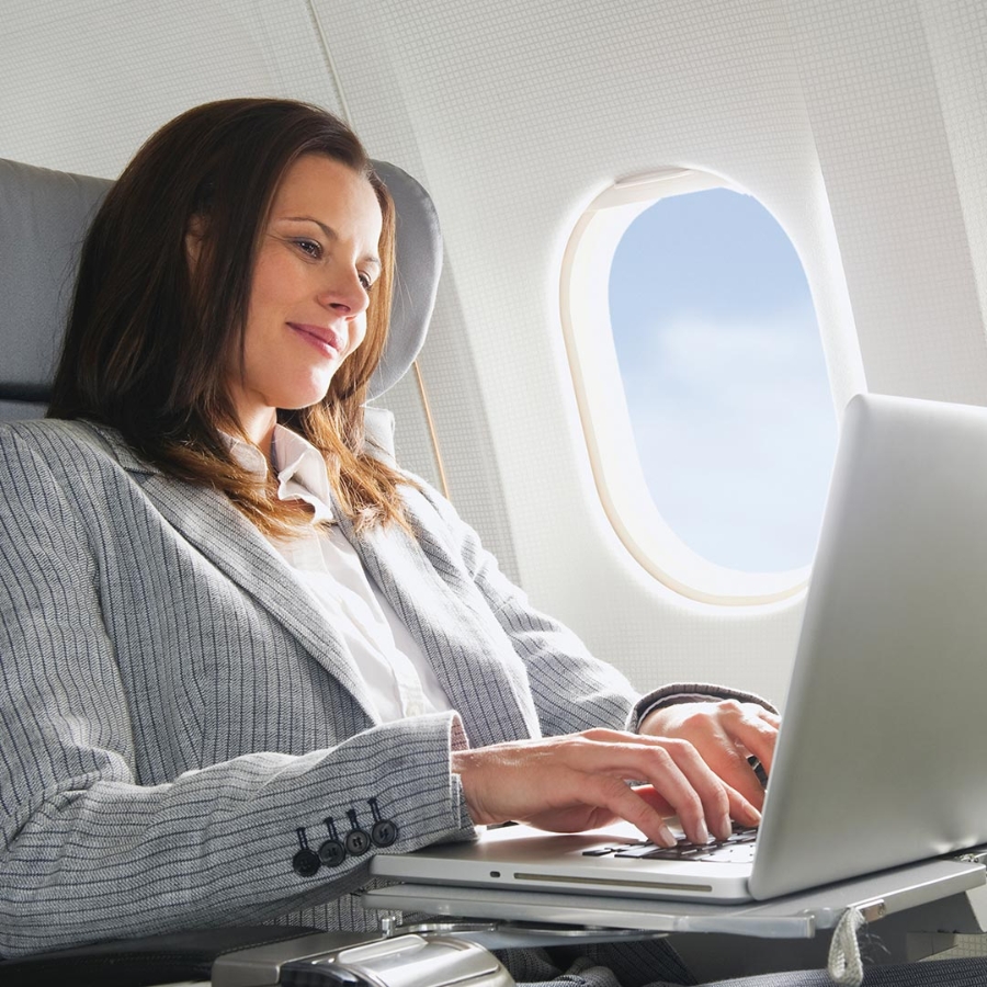 a business woman working on her laptop in flight