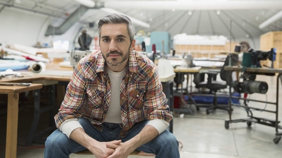 man bending forward while sitting on office chair