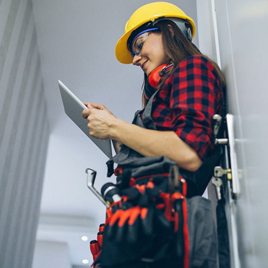 Female construction worker with tool