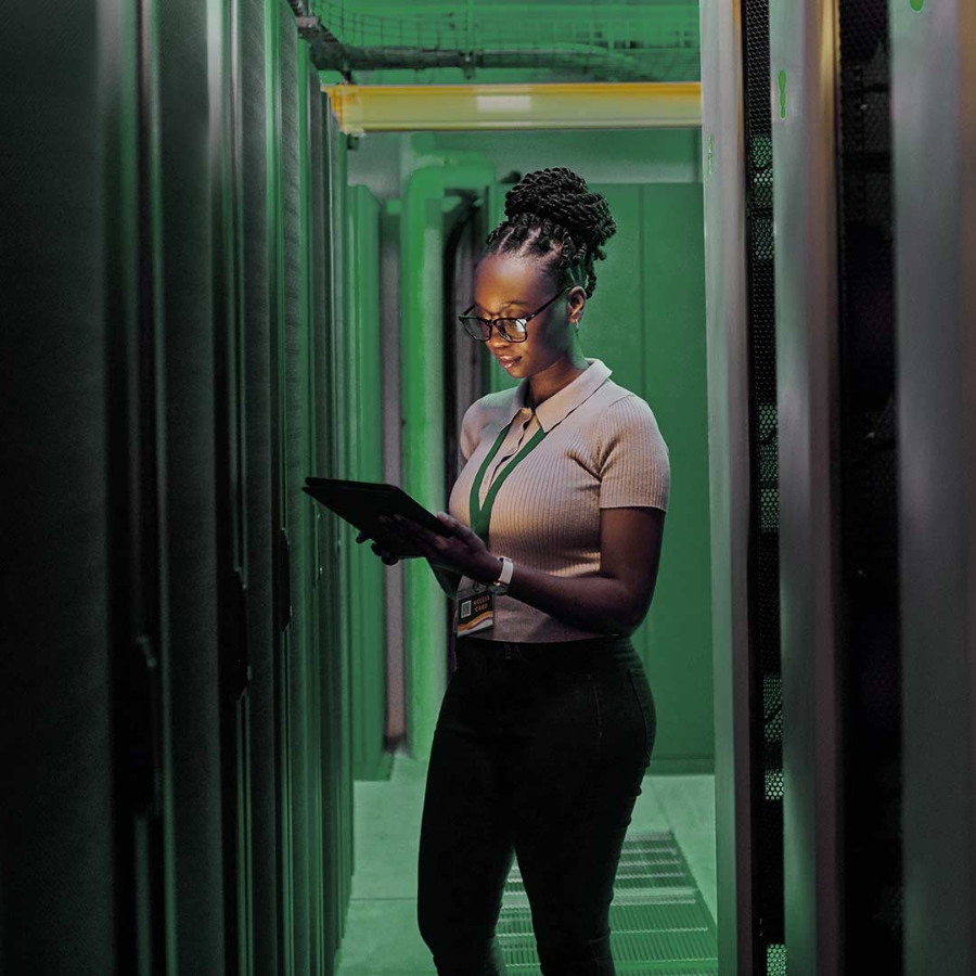 Shot of a young female engineer using a digital tablet while working in a server room