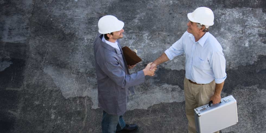Foremen shaking hands, field services