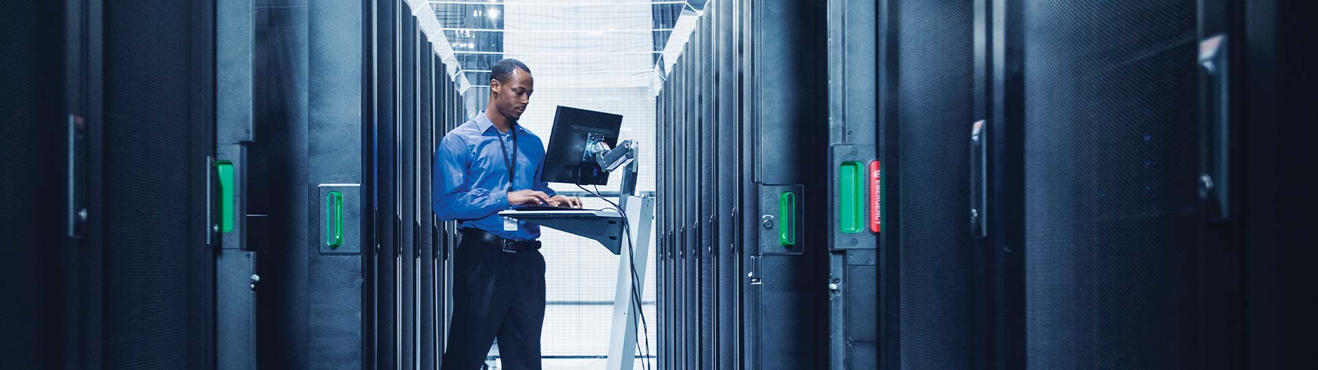 Black businessman using computer in server room, data center design