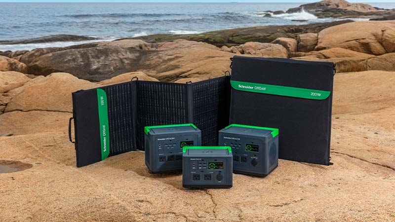 A group of electronic devices on a rocky beach