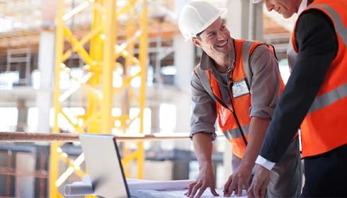 A person and person looking at a blueprint