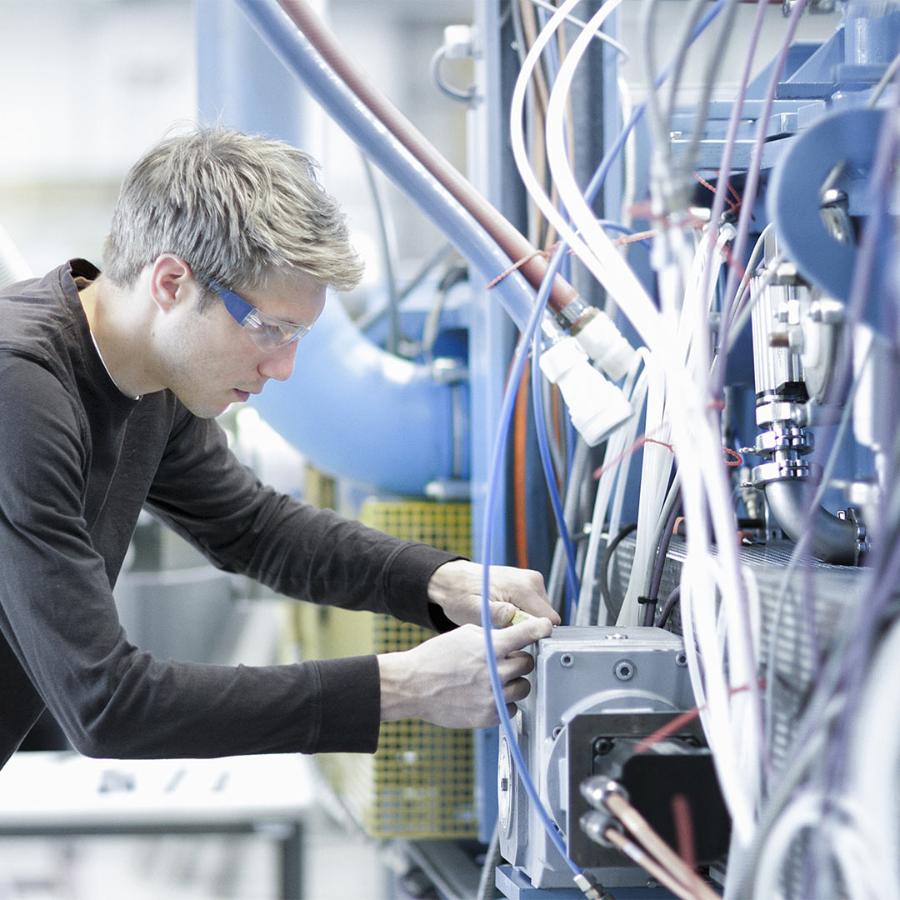 man inspecting wiring, machine solutions, industrial controls