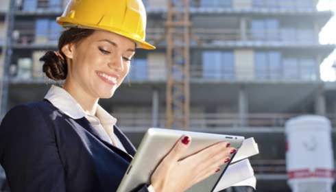 woman foreman on tablet checking against paperwork