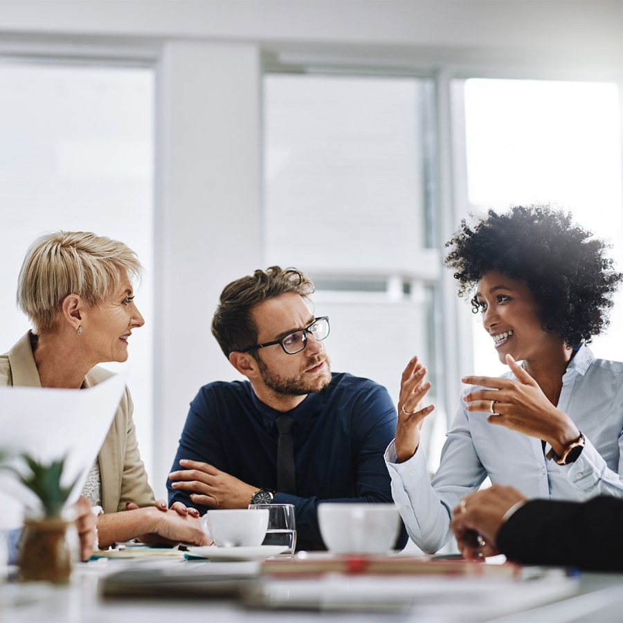 people in casual meeting talking and smiling