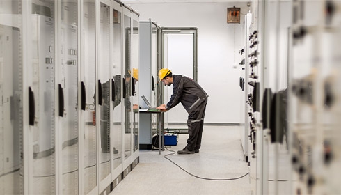 A person in a hard hat using a computer