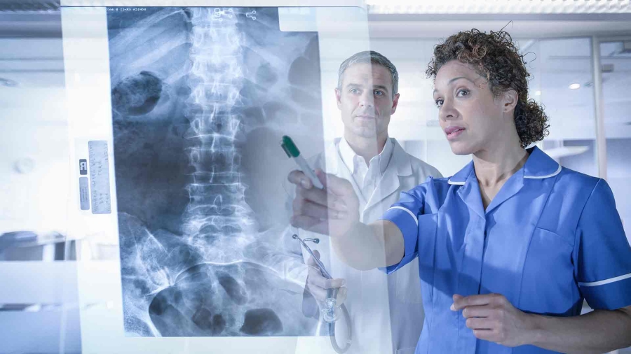 A male and a female doctor discussing an X ray at hospital