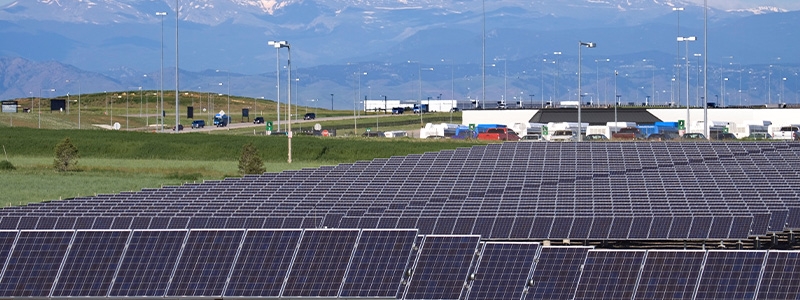 Standing near the terminal and parking, fields of solar panels provide electricity for smart airports infrastructure