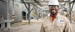 a smiling man in front of a facility