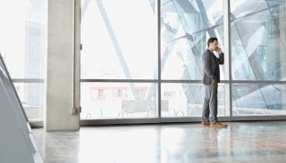 Businessman using mobile phone in office building