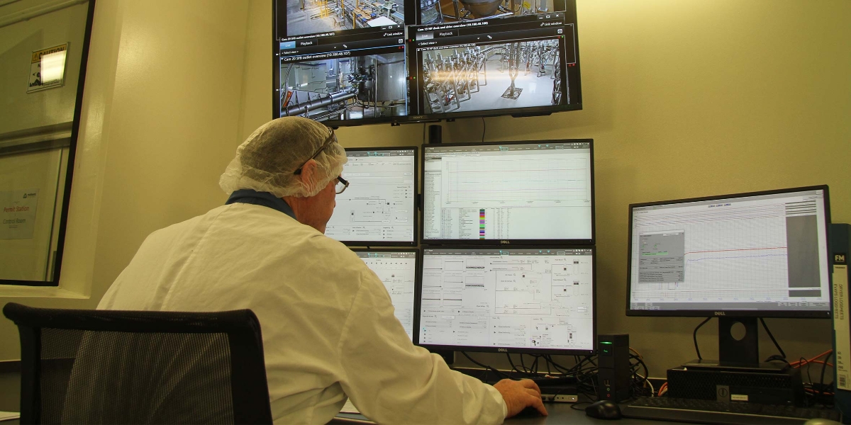 man working with computer screens