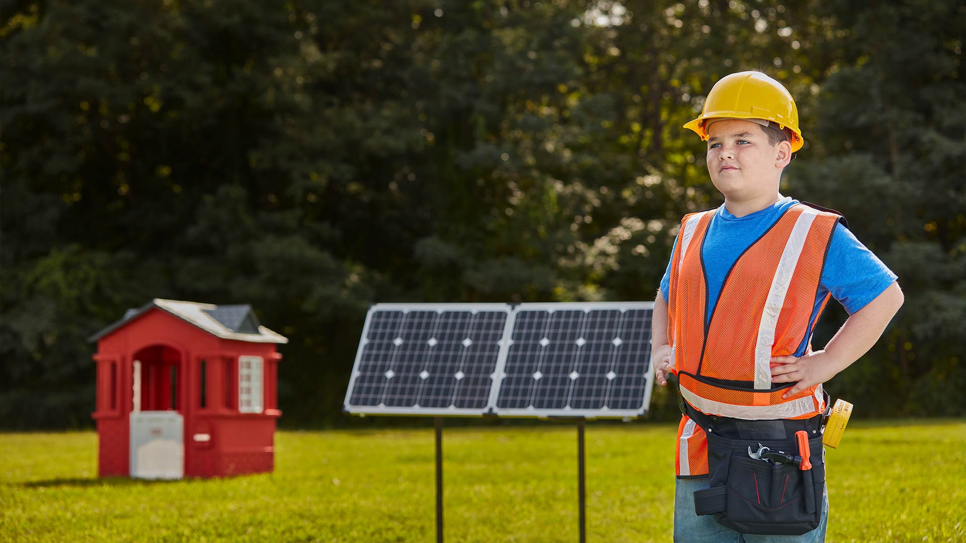 kid in front of solar panels