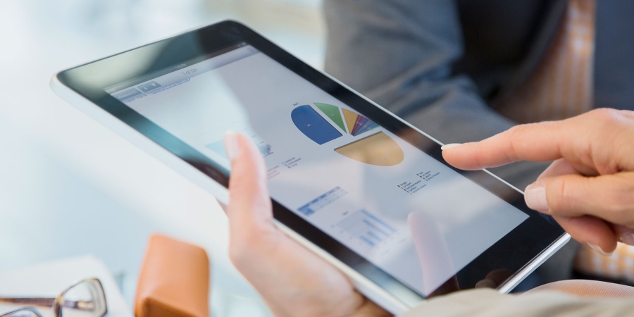 person viewing pie charts on a digital tablet