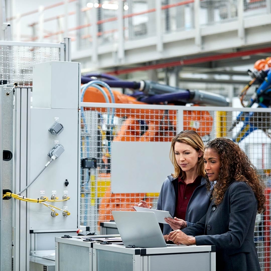 two women working on laptop and tablet