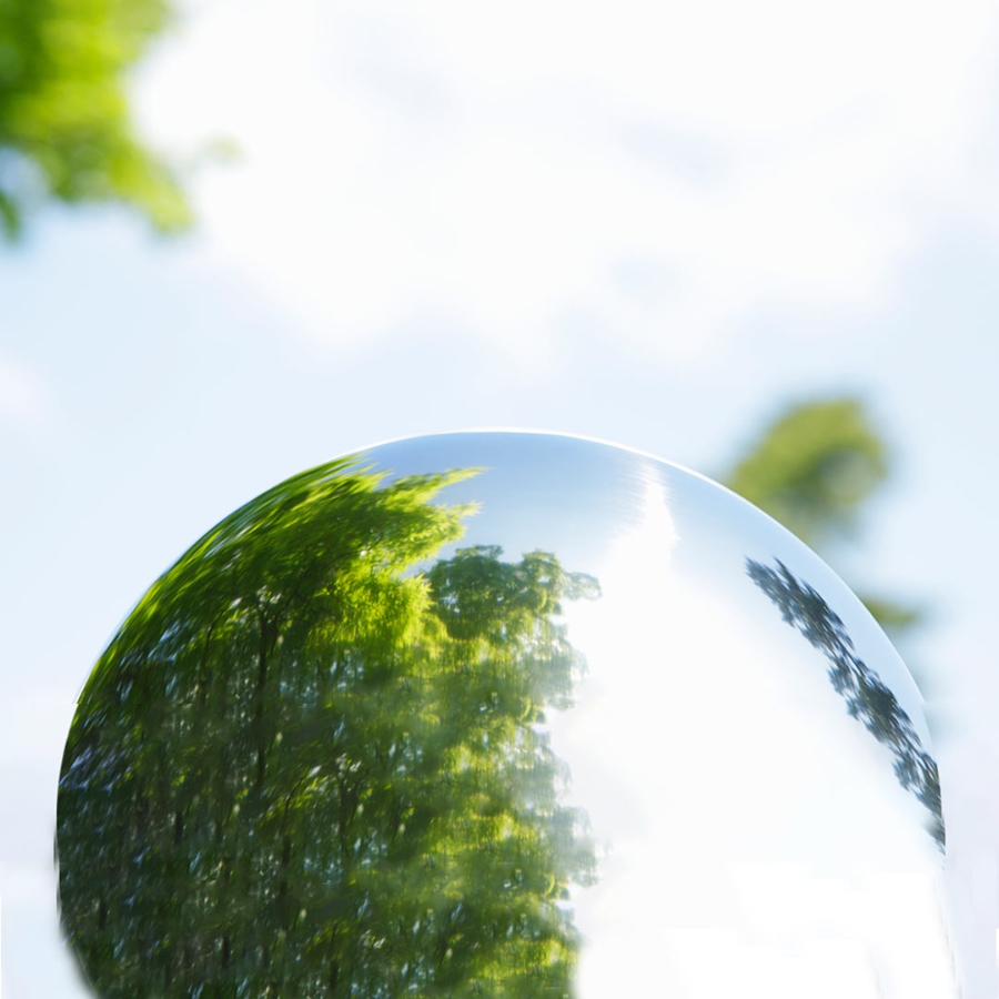 Glass sphere with reflection of trees and sky