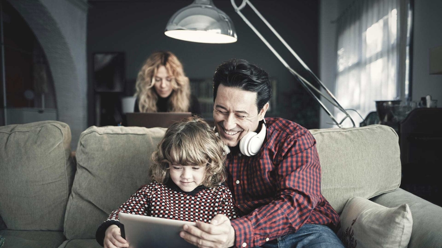 A person and child looking at a tablet