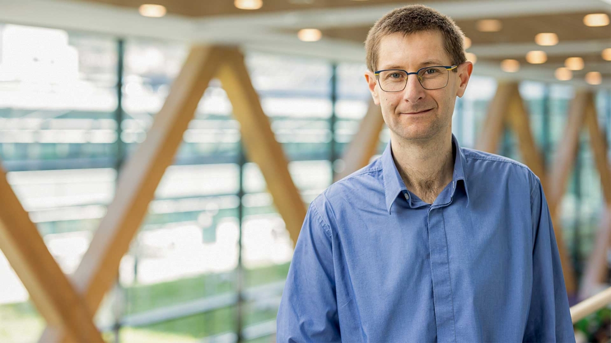 A person wearing glasses and a blue shirt