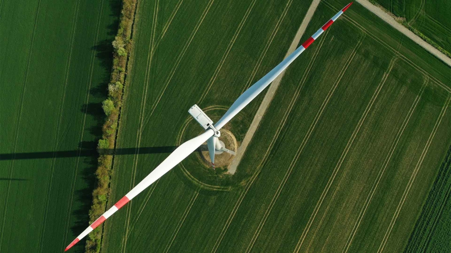 A white and red propeller in a field