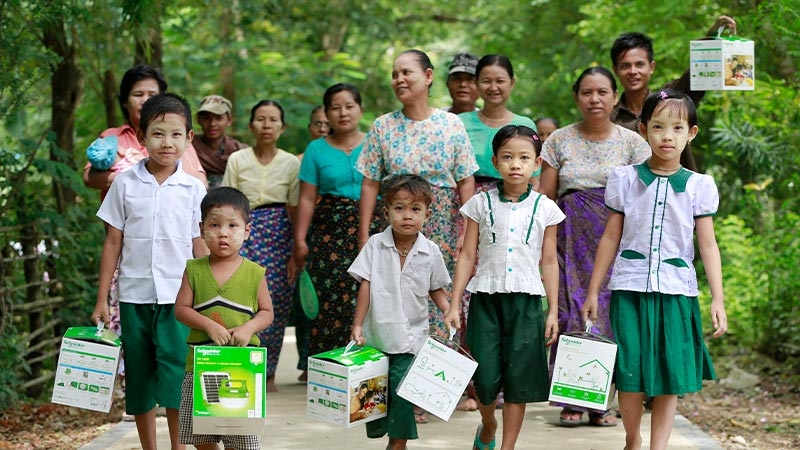 A group of people walking with boxes