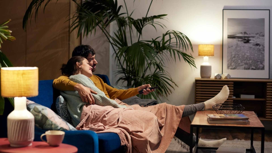 A person and person sitting on a couch
