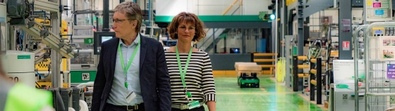 A group of people standing in a factory
