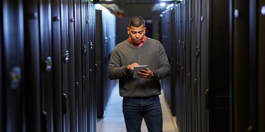 A person standing in a hallway with a tablet