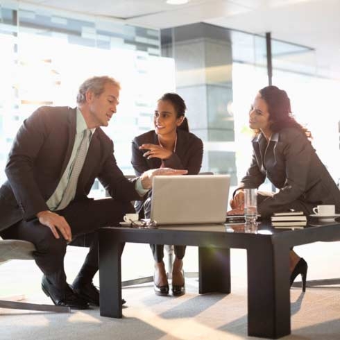 Business people with laptop meeting in lobby