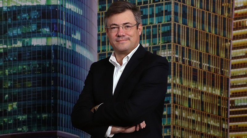 A person in a suit with his arms crossed