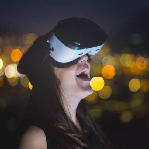 Woman wearing VR headset looking up at the night sky, Life is on