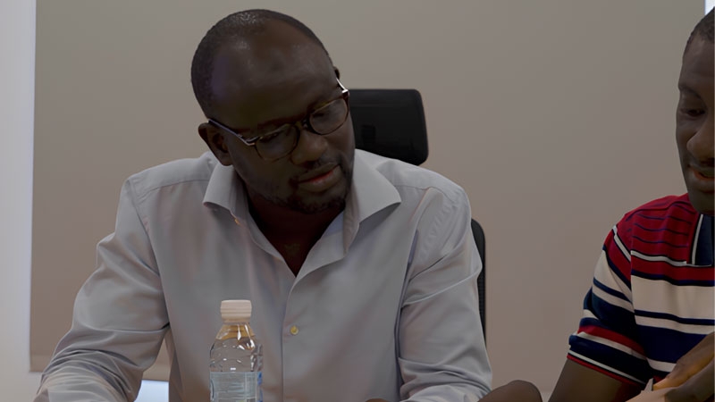Two African men discussing in office