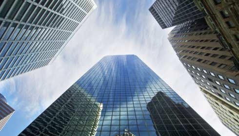 View of tall skyscrapers from below looking up, smart city.